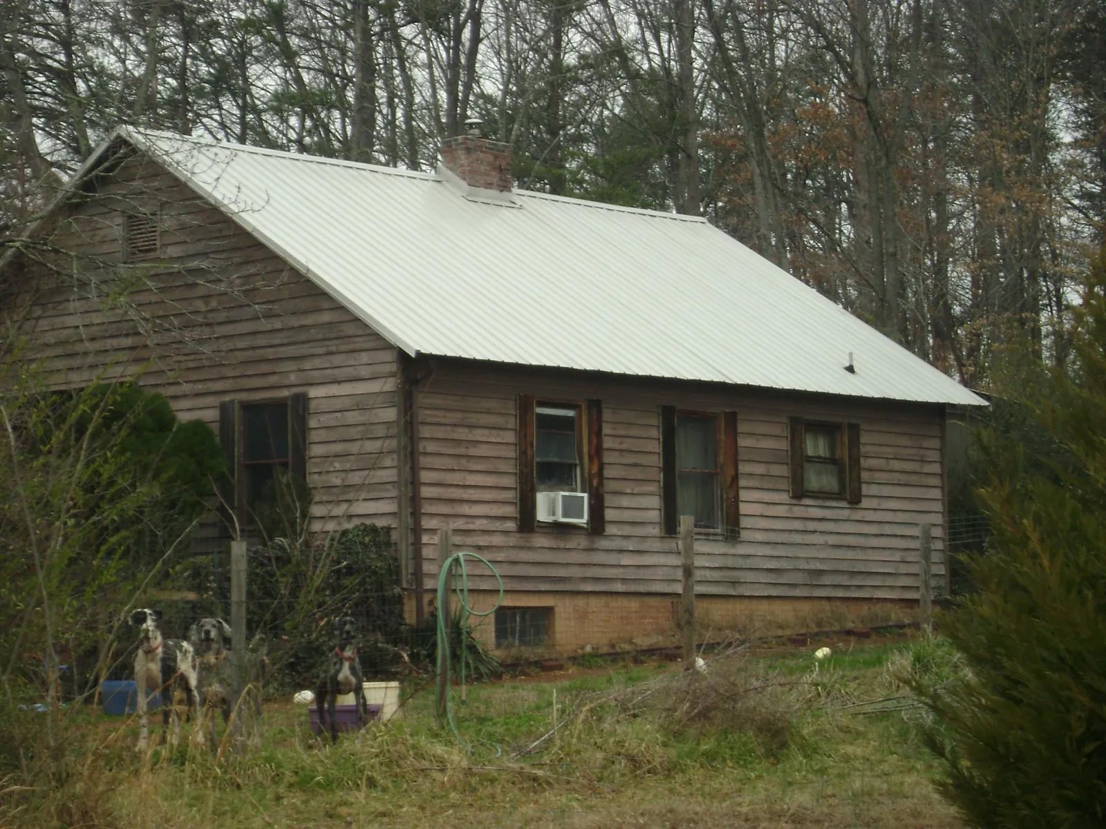 White metal roof on an old wood sided farmhouse, from a Asphalt Shingle Roof Repair job in Havensville